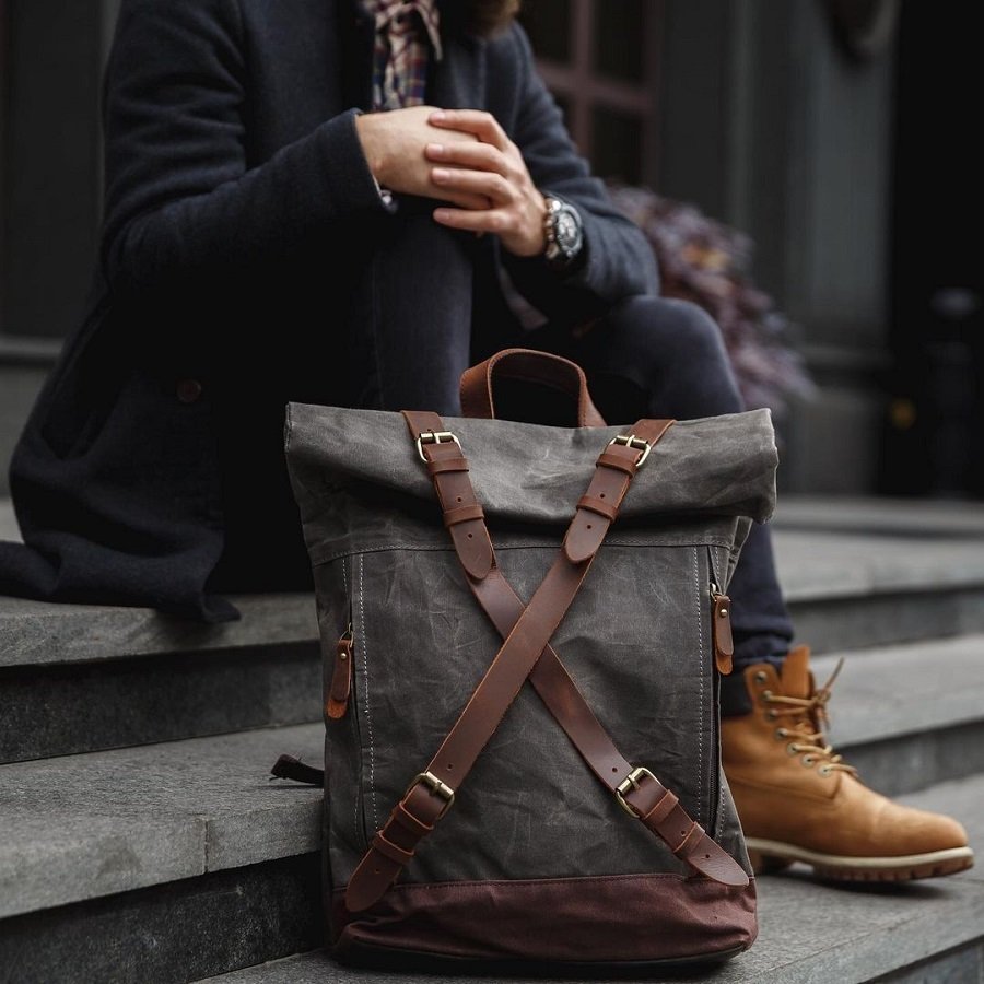 Vintage-Rucksack für Männer getragen mit einer Jeans und braunen Stiefeln